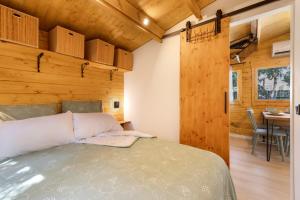 a bedroom with a bed and a wooden wall at Try and Try in Cunit +26 photos
