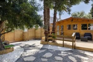a wooden house with a patio and trees at Try and Try in Cunit