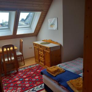 a bedroom with a bed and a desk and a table at Seekirchen Zentrum in Seekirchen am Wallersee