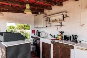 a kitchen with white cabinets and a counter top at Cozy Suite À Da Marina in Quinta do Poço