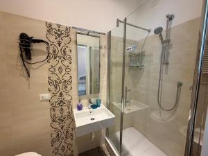 a bathroom with a shower and a sink and a shower at B&B Elisir in Albenga +38 photos