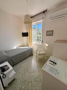 a bedroom with a bed and a desk and a chair at Hotel Dania in Sorrento