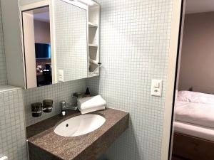 a bathroom with a sink and a mirror at Hotel Bären in Rothenburg