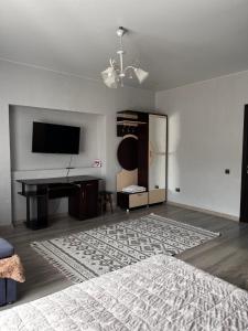 a living room with a piano and a television at У Лариси in Solochyn