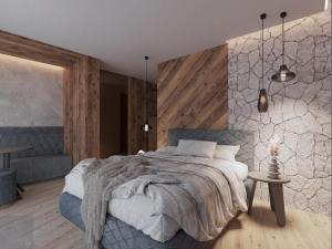 a bedroom with a large bed and a table at al Ritrovo - rooms & more in Andalo +6 photos
