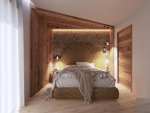 a bedroom with a large bed with a brick wall at al Ritrovo - rooms & more in Andalo