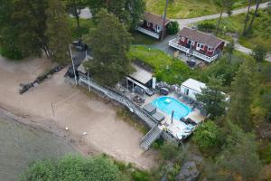 an aerial view of a house with a swimming pool at Airisto Hill & Inn - Two Beach Cabins in Haverö