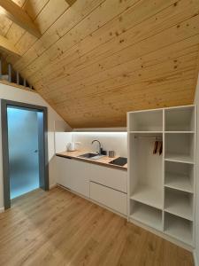 a kitchen with white cabinets and a wooden ceiling at Chalet La Martina in Zuberec +28 photos
