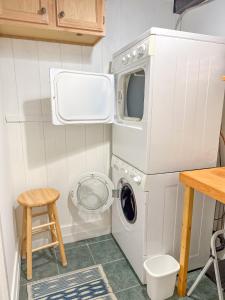 a washer and dryer in a small room with a table and stool at Chalet Valhalla wHot Tub in Sugarbush Village +43 photos