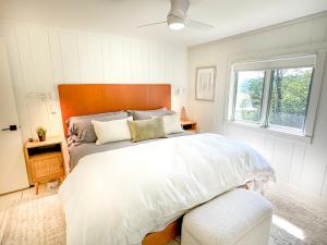 a bedroom with a large bed and a window at Chalet Valhalla wHot Tub in Sugarbush Village
