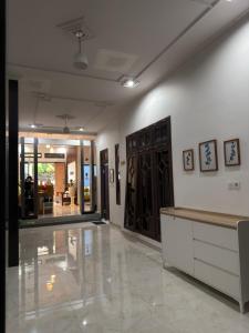 a room with a lobby with a counter and some doors at KalaKoala Hostel in Malang