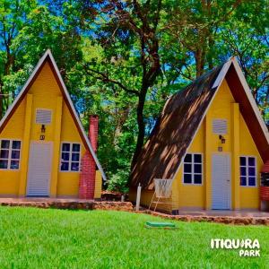 a yellow house with a gambrel roof at Itiquira Park Hotel in Formosa
