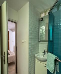 a bathroom with a sink and a mirror at Stone house Olsavinia close to the beach in Kaštela +34 photos