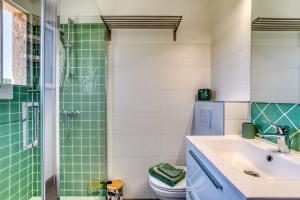 a bathroom with a sink and a shower at Les Pénates De Mélilotte in Clermont-lʼHérault +22 photos