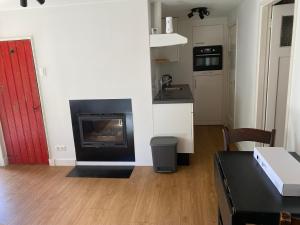 a living room with a fireplace and a table at Den Doezel in Vorden