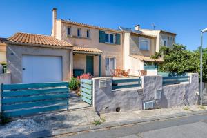 a house with a fence in front of it at Les Pénates De Mélilotte in Clermont-lʼHérault
