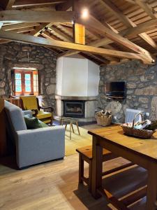 a living room with a couch and a table at Casas da Peneda - Geres in Gavieira