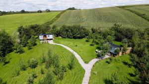 an aerial view of a house in the middle of a field at Da Vinci's Den in North Tawton