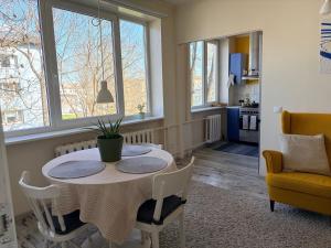 a dining room with a table and a chair at Nice apartment close to the beach in Tallinn