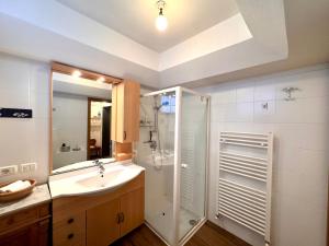 a bathroom with a sink and a shower at Villa ai noci in Carano