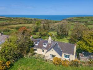 an aerial view of a house with the ocean in the background at 2 Caerau Isaf in Haverfordwest +32 photos
