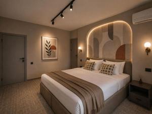 a bedroom with a large bed with an arched window at The Destan Hotel and Terrace in Baku