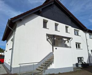 a white building with a black roof at Ferienwohnung „Prims“ in Wadern
