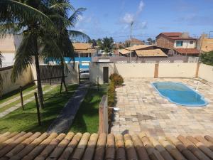 a view of a backyard with a swimming pool at Paraíso do Abais, house for rent in Estância