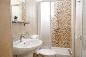 a bathroom with a sink and a toilet and a shower at Sharon Court Guesthouse in St. Paul's Bay +111 photos