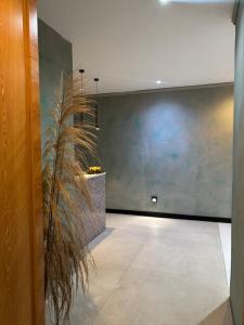 a hallway with a large wall and a plant at Hotel Credo in Kotor +30 photos