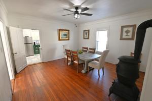 a kitchen and dining room with a table and a stove at The Sago Palm House in Thomasville