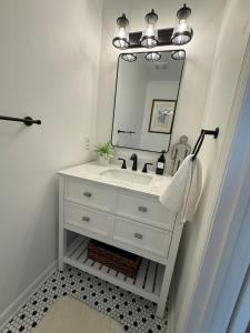 a bathroom with a white sink and a mirror at The Sago Palm House in Thomasville +30 photos
