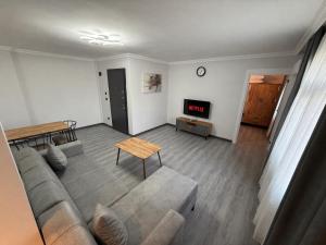 a living room with a couch and a tv at Twelve Diamond Hotel12 in Istanbul