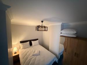 a small bedroom with a bed and a chandelier at Twelve Diamond Hotel12 in Istanbul