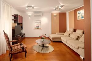 a living room with a couch and a table at Heritage House Pjaca, Omiš in Omiš