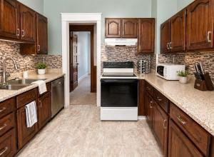 a kitchen with wooden cabinets and a stove top oven at Boulevard Park Apartments in Erie