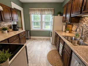 a kitchen with a sink and a refrigerator at Boulevard Park Apartments in Erie +8 photos