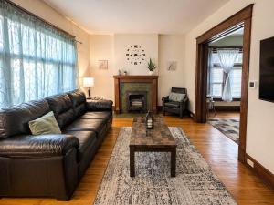a living room with a leather couch and a table at Boulevard Park Apartments in Erie