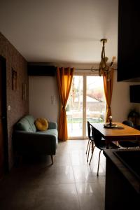 a living room with a couch and a table at Bélénos - Suites & Spa in Bligny-sur-Ouche