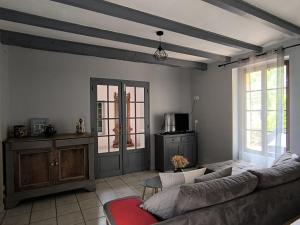 a living room with a couch and a table at Gîtes BEAUSOLEIL in Campsegret