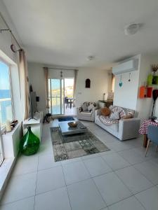 a living room with a couch and a table at Very nice place by the sea in Is-Sellum