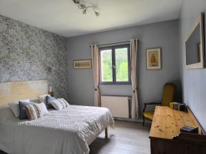 a bedroom with a bed and a table and a window at Gîtes BEAUSOLEIL in Campsegret +13 photos