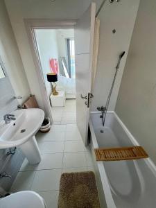 a white bathroom with a tub and a sink at Very nice place by the sea in Is-Sellum +29 photos