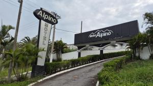 aania sign on a road next to a building at Alpino Motel by Drops in Jundiaí +12 photos
