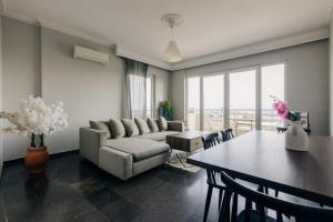 a living room with a couch and a table at Panoramic Apartment in Chios
