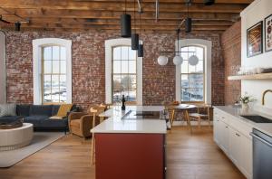 an open kitchen and living room with a brick wall at The Evalina Hotel in Portland