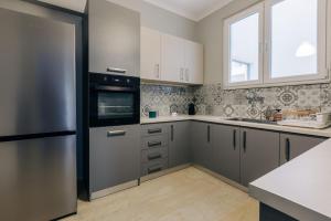 a kitchen with stainless steel appliances and a window at Panoramic Apartment in Chios