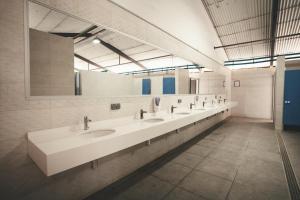 a bathroom with three sinks and a large mirror at Tres Estrellas Barcelona by HolaCamp in Gavà +37 photos