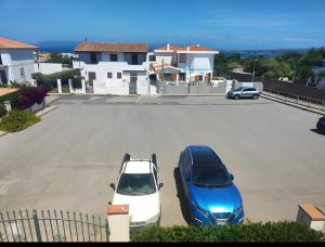 two cars parked in a parking lot in a driveway at Casa Scopelliti Calasetta in Calasetta