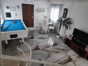 a living room with a pool table on a marble floor at Casa Scopelliti Calasetta in Calasetta